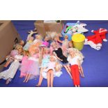 A collection of Barbie and Ken dolls, together with a selection of dolls clothes and accessories