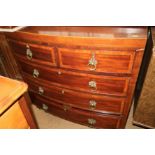 An early 19th century mahogany and satinwood banded bowfront chest of two short and three long