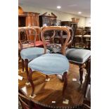 A Harlequin set of six walnut carved bar back standard dining chairs, upholstered in a blue