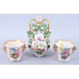A pair of 19th century Derby porcelain cachepots, decorated floral panels on a pink ground, 4 1/4"