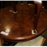 A 19th century figured walnut oval loo table, on turned and carved quadruple splay supports, 53"
