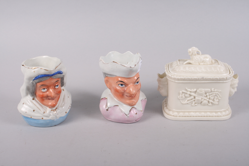 A pair of 19th century porcelain Punch and Judy jugs, 5" high, and a butter dish and cover