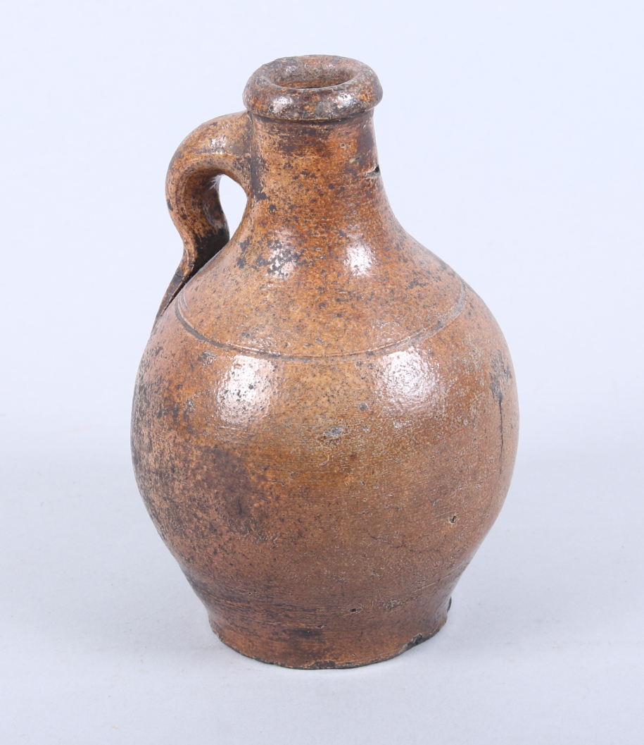 A 17th century Continental brown salt glazed stoneware jug, 6 1/2" high