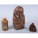 A Chinese carved bamboo figure of a Kylin, 10 1/2" high, a carved bamboo figure of a seated deity,