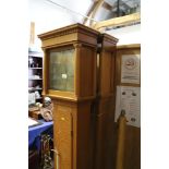 Two modern oak longcase clock cases, one with brass dial and one with three train movement, 72"