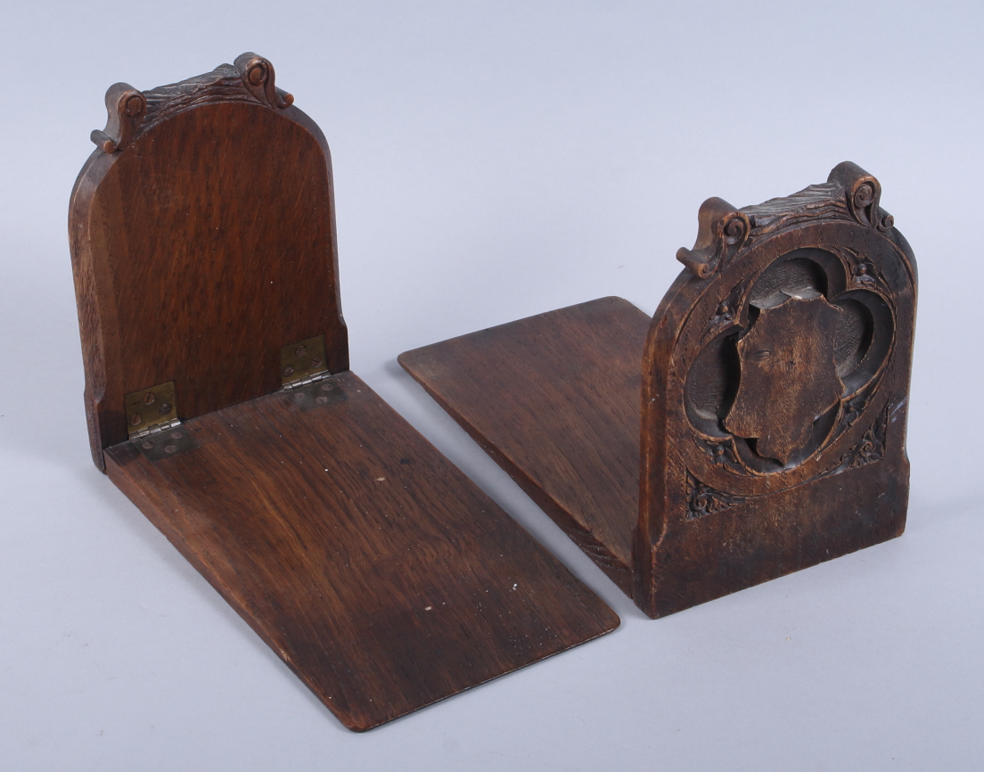 A pair of Victorian Gothic carved oak bookends