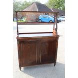 An early 19th century rosewood and gilt brass mounted chiffonier with two open shelves over