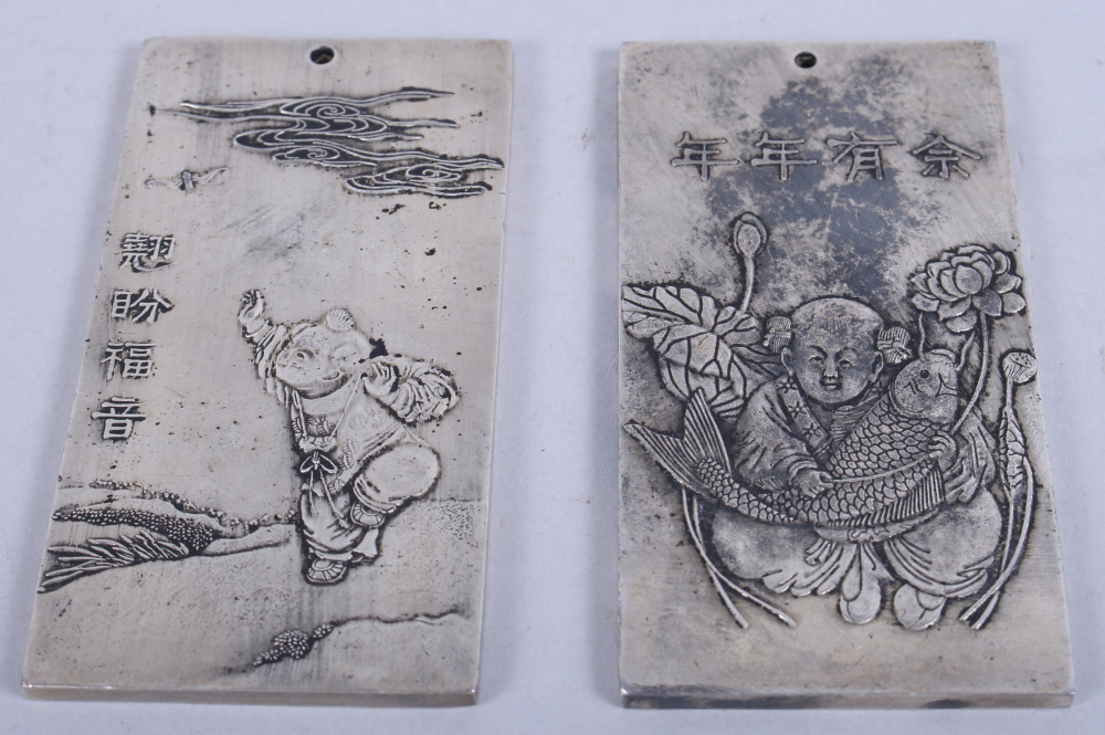 A pair of Chinese Zodiac silvered ingots, children, 4" long