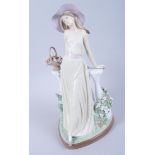 A Lladro figure of a girl leaning on a balustrade, 14" high