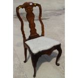 An early 18th century carved walnut and banded splat-back side chair, on cabriole stretchered
