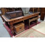 A 19th century mahogany library table, fitted one long and two short drawers, inset leather top,