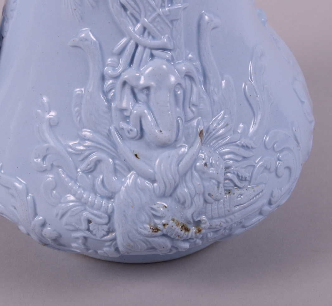 A 19th century blue glazed relief moulded jug, decorated exotic animals and war trophies (Europe and - Image 4 of 7
