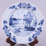 An 18th century Delft dish, decorated landscape and floral border, 7 3/4" dia