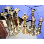 A pair of brass fluted column altar candlesticks, 19" high, two similar and five other candlesticks