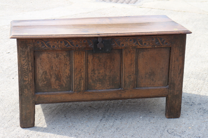 An 18th century oak triple panel front coffer, on stile supports, 44" wide