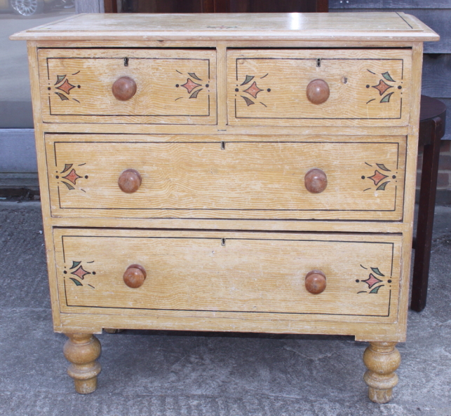 A painted and grained chest of two short and two long drawers with knob handles, on turned supports,