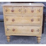 A painted and grained chest of two short and two long drawers with knob handles, on turned supports,
