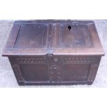 A 17th century carved oak panel front coffer with staple hinges and candle box (no base), 31 1/2"