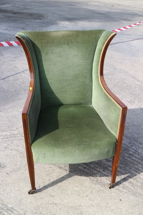 A late 19th century mahogany showframe scroll armchair, upholstered in a red velour, on turned