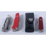 Three Swiss Army knives and a similar penknife