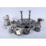 A pair of 19th century pewter candlesticks, a lidded tankard, three pewter dishes and various