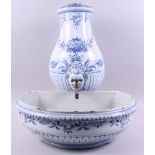 A Continental delftware water fountain and matching bowl with blue and white scroll and mask