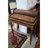 A lady's mahogany and brass bound writing table, fitted tambour top and one long drawer, on reeded