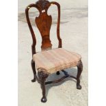 An early 18th century carved walnut splat-back side chair, on cabriole stretchered supports