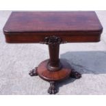 An early Victorian mahogany fold-over top card table, on turned column and quadruple lion paw