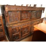 A 17th century carved oak duedarn, the upper section fitted two doors over two further doors, 73"
