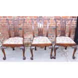 A set of three Irish caved walnut side chairs with pierced splats and drop-in seats, on shell carved