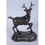 A 19th century Chinese bronze model of a stag, on pierced shaped base, 12 1/2" high