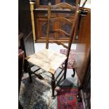 Two 19th century oak and ash ladder back chairs with rush envelope seats, on turned and