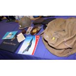 A mid 20th century crew captain's coat and matched cap, a military cap, a canvas bag, a regimental