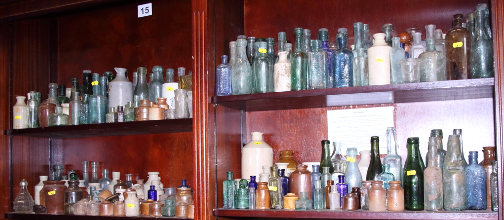 A large collection of glass and ceramic pharmaceutical, medicinal, ink and other bottles