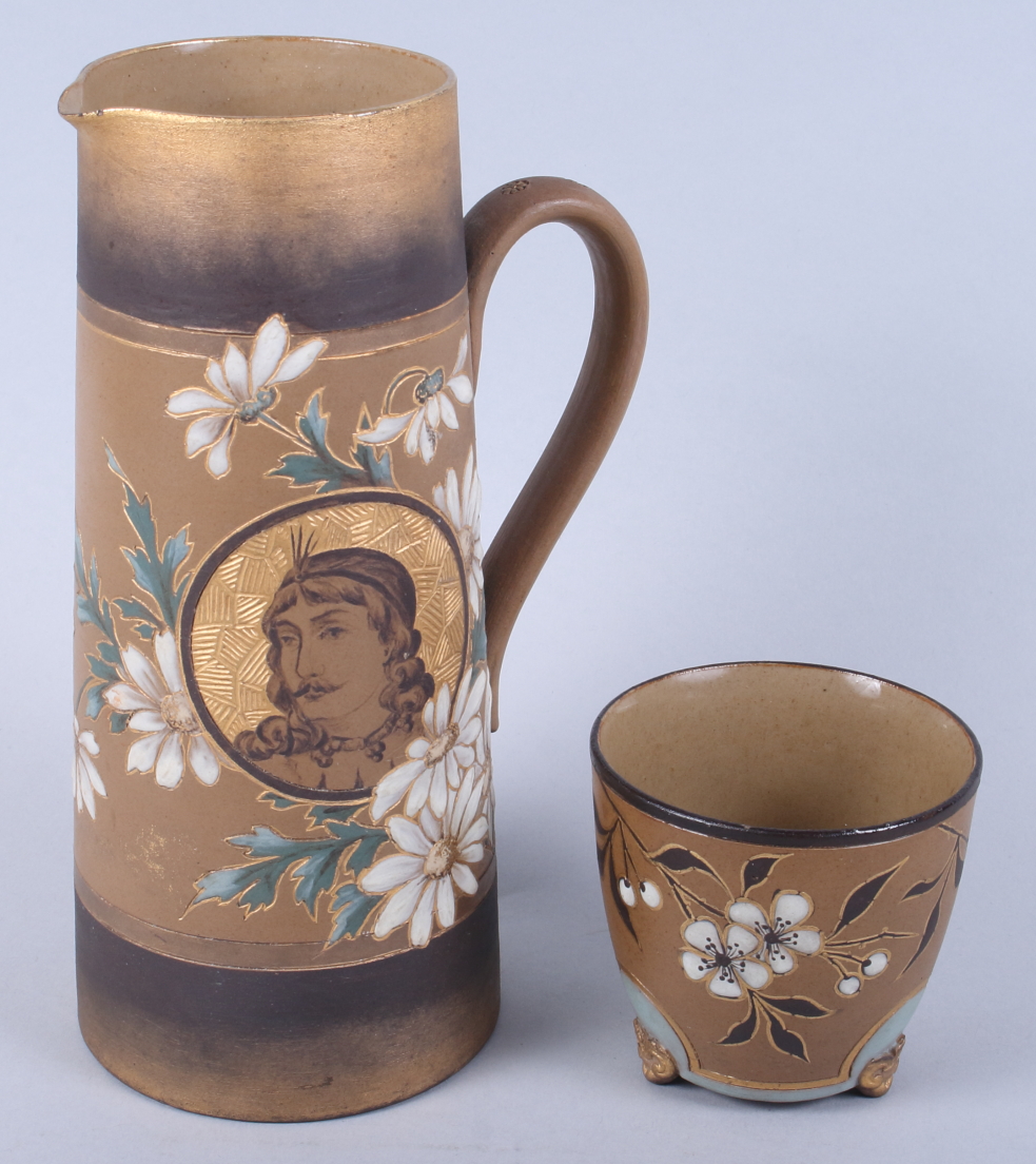 A Doulton Lambeth siliconware jug with slip and gilt decoration of flowers and a portrait of a
