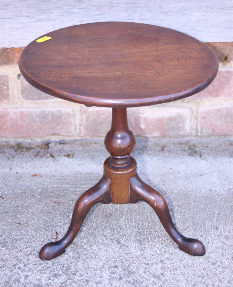 A late Georgian mahogany miniature tilt top table, on turned column and tripod splay support with