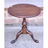 A late Georgian mahogany miniature tilt top table, on turned column and tripod splay support with