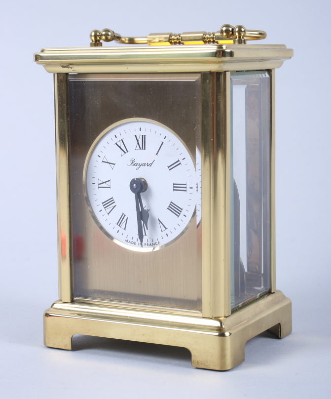 A French gilt metal eight-day carriage clock with seven jewel movement, white enamel dial and