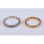 A 22ct gold wedding band, 4.9g, and a 9ct gold eternity ring, 2.2g