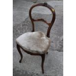 A Victorian carved walnut loop back side chair with stuffed over seat, on cabriole supports