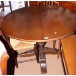 An oak circular extending dining table, on turned carved column, a nest of three polished as