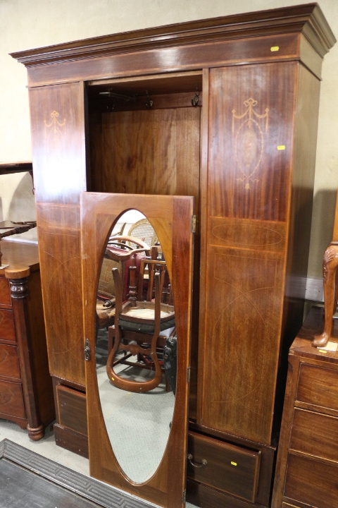 An Edwardian walnut and inlaid wardrobe enclosed centre mirror door over one drawer, 51" wide