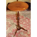 A 19th century fruitwood occasional table, on turned column and tripod splay support, 14" dia