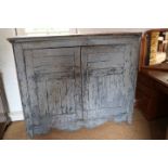 A late 19th century blue painted "American" pine side cupboard enclosed panelled doors, on block