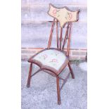 An Edwardian polished as mahogany side chair with shaped padded back and seat, on turned and