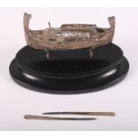 A Maltese filigree silver model boat with oars, on oval base, boat 3 1/4" long