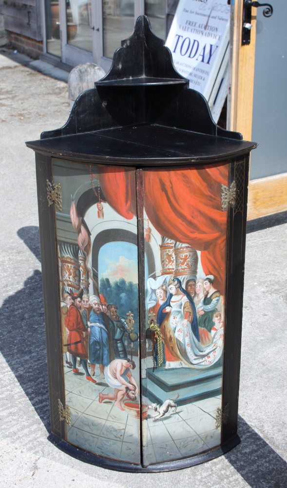 A late 18th century Continental painted corner cupboard, "Queen Thomyris with the head of King