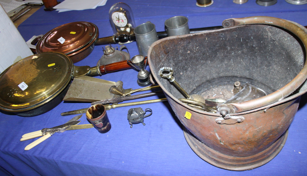 A copper coal helmet, two warming pans, a brass door stop and various other metalwares