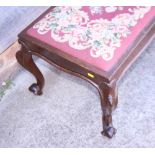A carved walnut duet/window stool with needlepoint seat, on cabriole supports, 40" wide